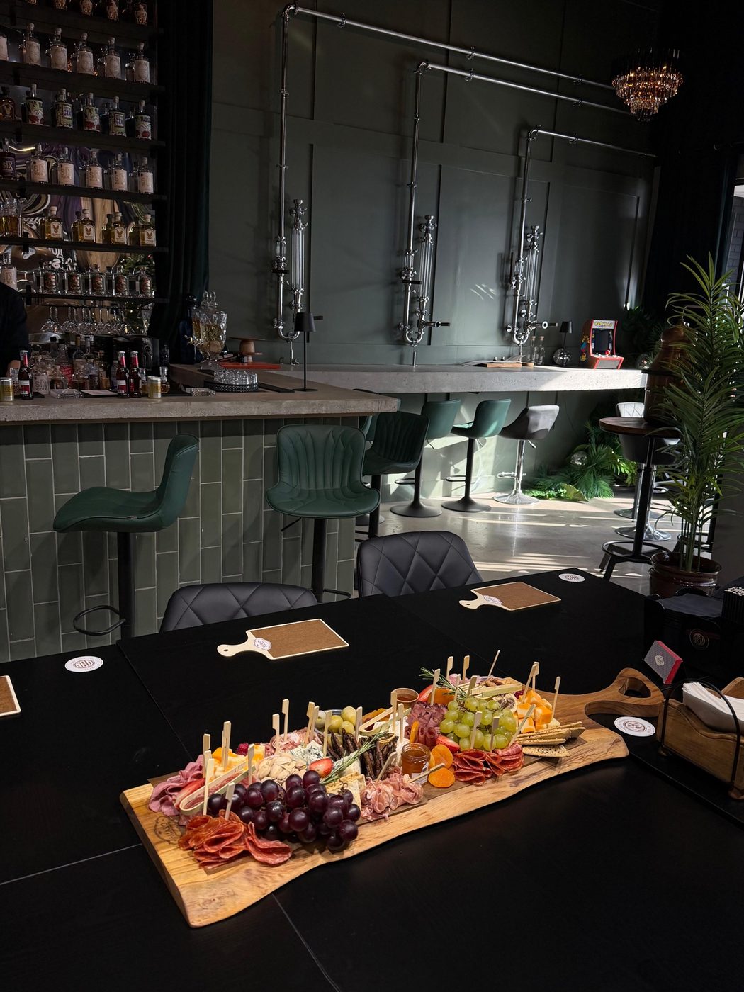 A MIASO charcuterie board served at a table inside North Spirit Distillery