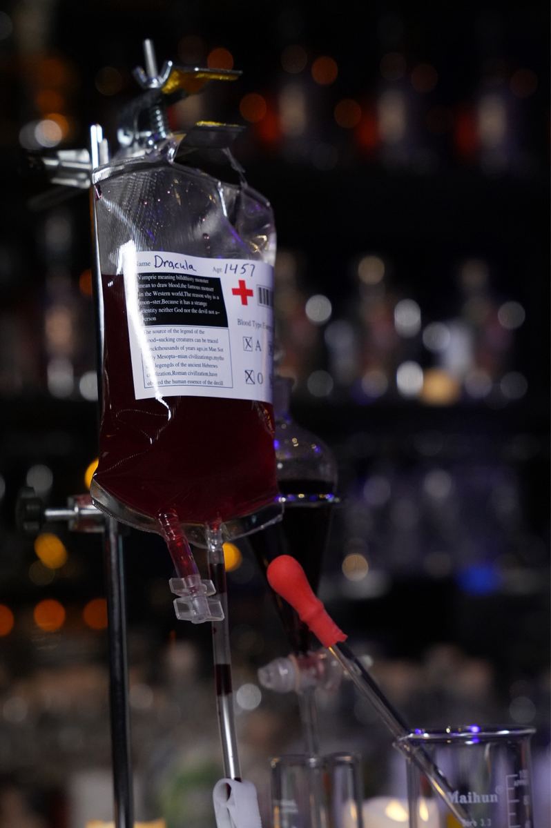 A red cocktail served from an IV bag